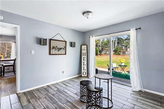 dining area featuring baseboards and dark wood-type flooring
