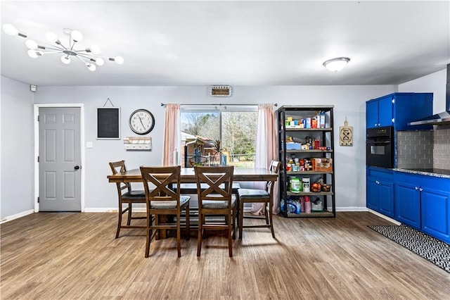 dining space featuring baseboards and light wood-style floors