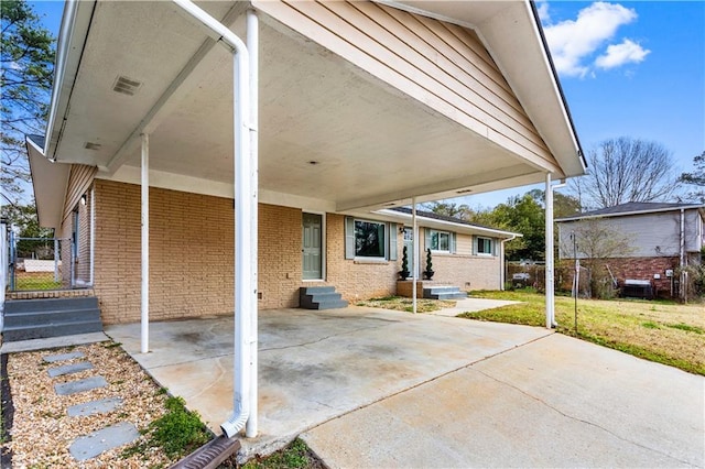 view of patio / terrace featuring entry steps and an attached carport