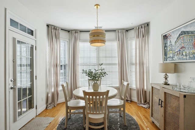 dining space featuring light wood-type flooring