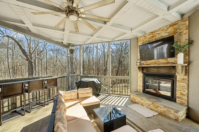 view of patio featuring an outdoor living space with a fireplace, grilling area, and ceiling fan