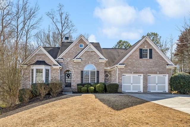 view of front of property with a front yard and a garage