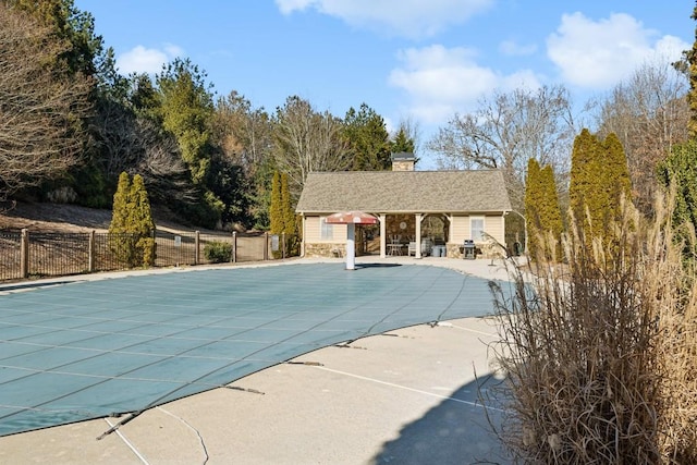 view of swimming pool featuring a patio area and an outbuilding