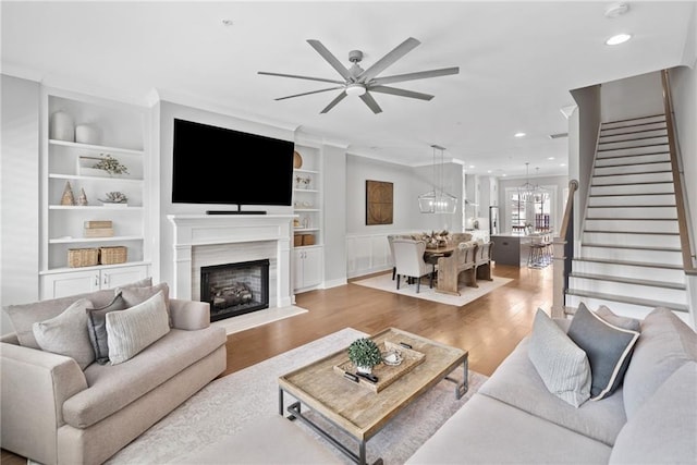 1104 Thomas St, Woodstock, GA 30188 - living area with a ceiling fan, stairway, built in shelves, light wood-style flooring, and a fireplace