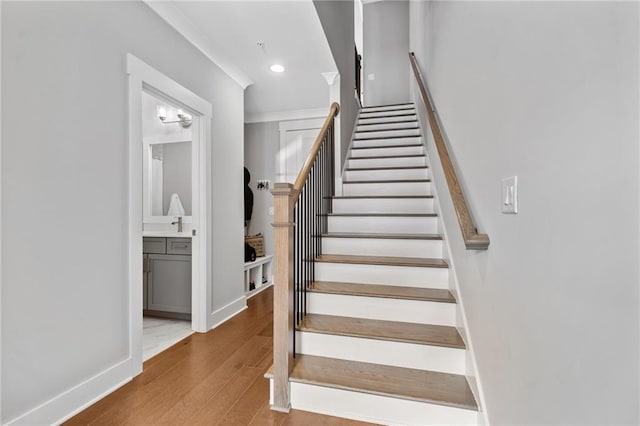 1104 Thomas St, Woodstock, GA 30188 - staircase with wood finished floors, recessed lighting, and ornamental molding