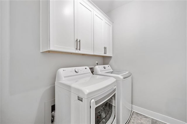 1104 Thomas St, Woodstock, GA 30188 - laundry area with cabinet space and washing machine and dryer