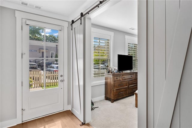 1104 Thomas St, Woodstock, GA 30188 - doorway to outside featuring plenty of natural light, a barn door, and light wood-style floors