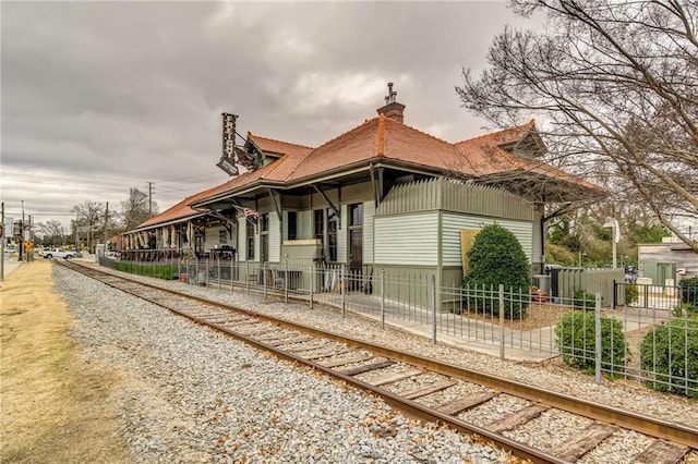 1104 Thomas St, Woodstock, GA 30188 - view of home's exterior featuring a chimney and covered porch