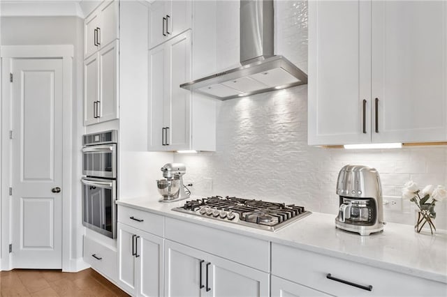 1104 Thomas St, Woodstock, GA 30188 - kitchen with wall chimney range hood, appliances with stainless steel finishes, white cabinetry, and tasteful backsplash