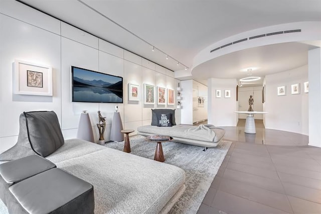 living room featuring vaulted ceiling and track lighting