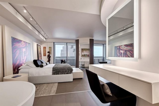 tiled bedroom featuring track lighting