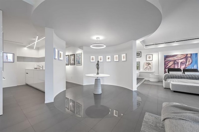 interior space featuring tile patterned flooring and baseboards