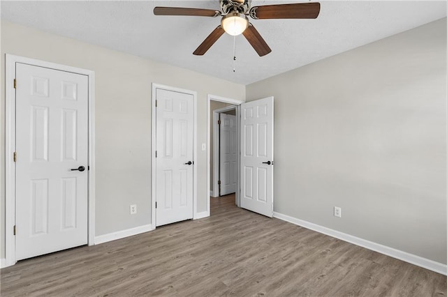 unfurnished bedroom featuring ceiling fan and light hardwood / wood-style floors