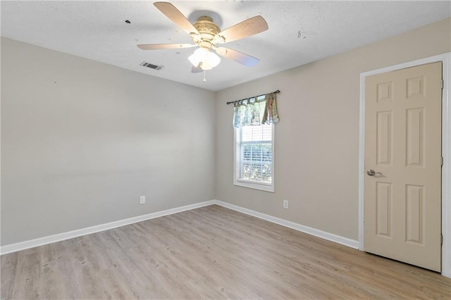 spare room featuring ceiling fan and light hardwood / wood-style flooring