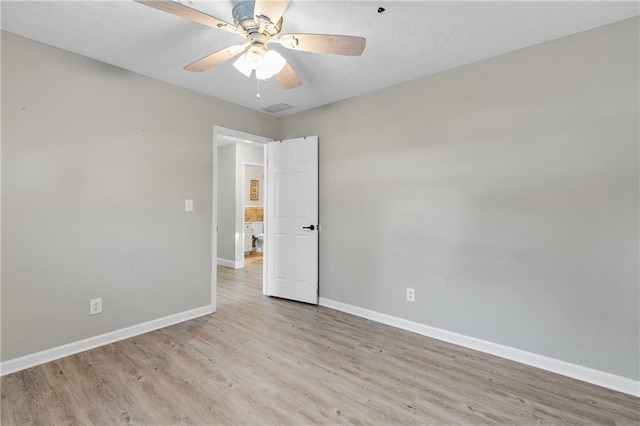 spare room featuring ceiling fan and light hardwood / wood-style floors