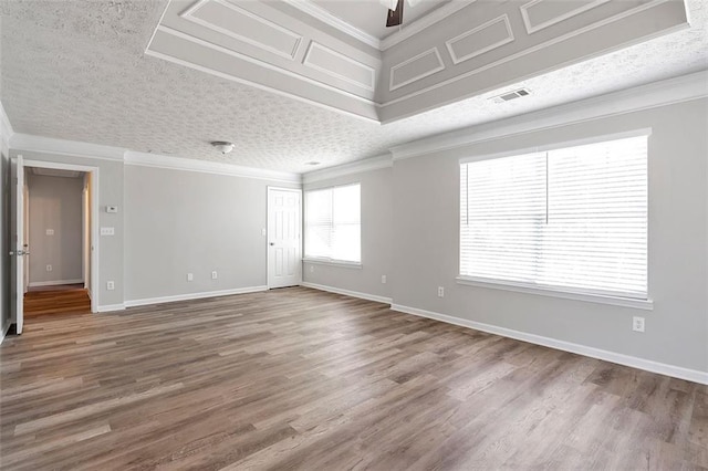 unfurnished room with ornamental molding, hardwood / wood-style floors, ceiling fan, and a textured ceiling