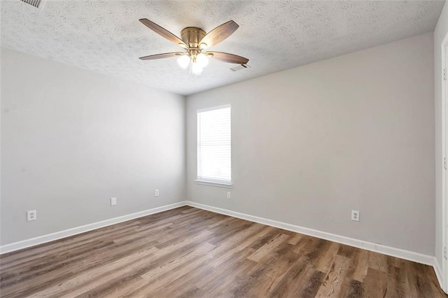 spare room with wood-type flooring, a textured ceiling, and ceiling fan