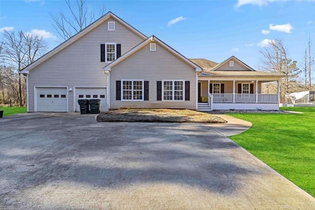 view of front facade featuring a garage, a front lawn, and a porch