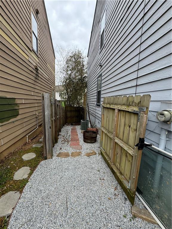 view of side of home featuring a patio area and fence