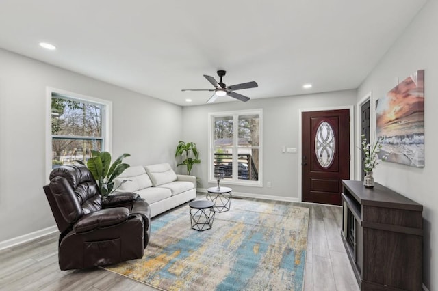 living room featuring recessed lighting, plenty of natural light, and wood finished floors