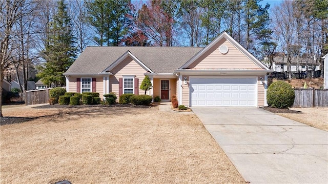 single story home with a garage, driveway, and fence