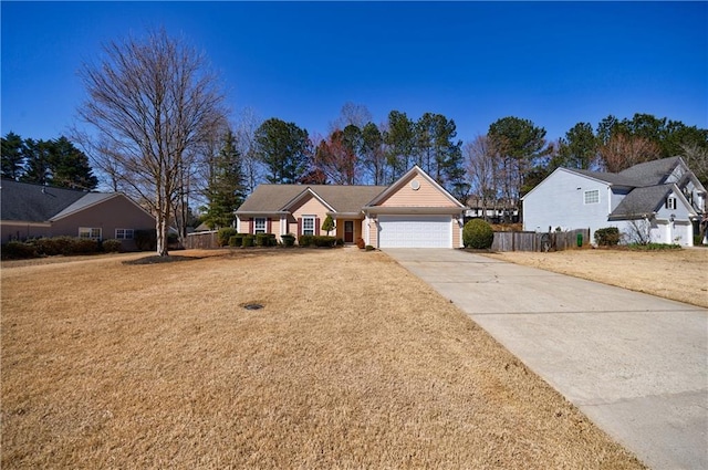 view of front of house with a garage, fence, a front lawn, and concrete driveway