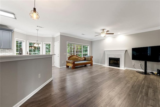 2994 Meadow Church Rd, Suwanee, GA 30024 - living room with dark wood-type flooring, a ceiling fan, a premium fireplace, baseboards, and ornamental molding