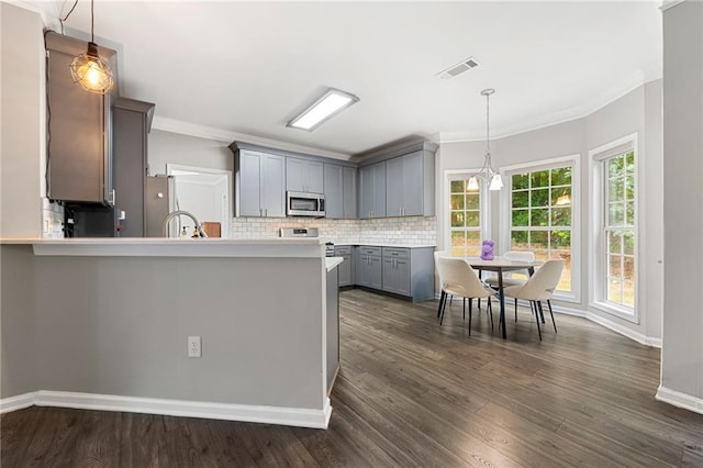 2994 Meadow Church Rd, Suwanee, GA 30024 - kitchen with appliances with stainless steel finishes, gray cabinetry, ornamental molding, backsplash, and baseboards