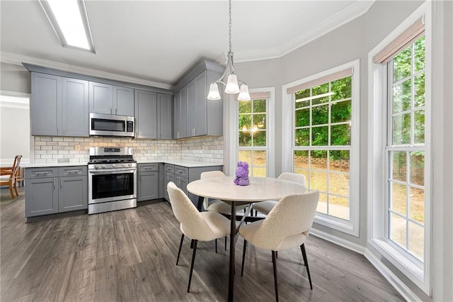 2994 Meadow Church Rd, Suwanee, GA 30024 - kitchen with stainless steel appliances, gray cabinets, crown molding, decorative backsplash, and dark wood-style flooring