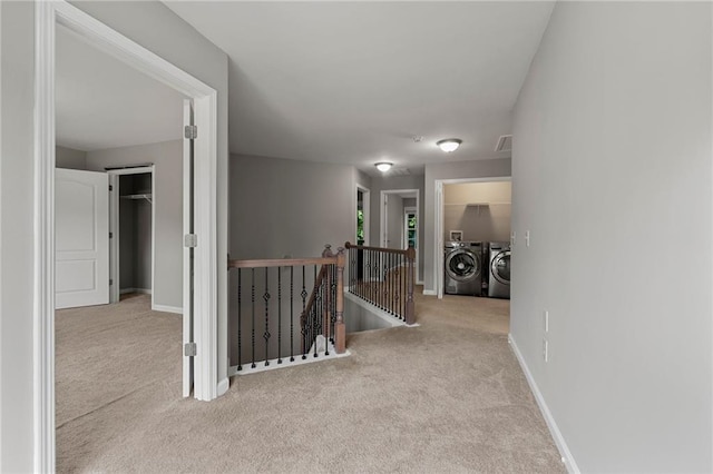 2994 Meadow Church Rd, Suwanee, GA 30024 - hall featuring an upstairs landing, carpet floors, washing machine and clothes dryer, and baseboards