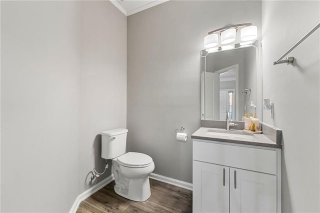 2994 Meadow Church Rd, Suwanee, GA 30024 - half bathroom with toilet, vanity, ornamental molding, wood finished floors, and baseboards