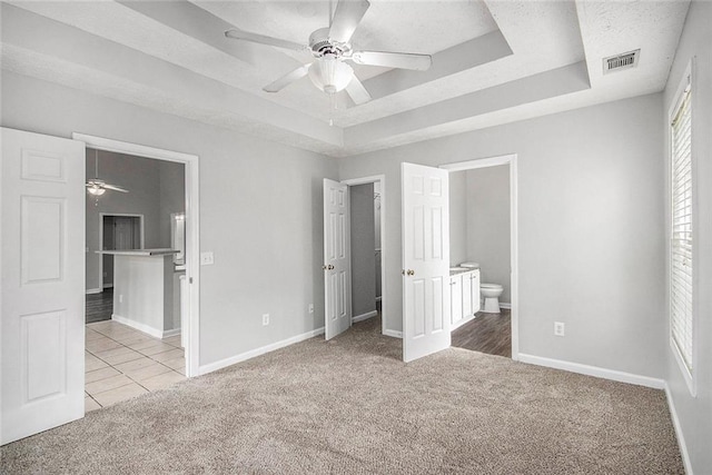 104 Terrapin Ct, Carrollton, GA 30116 - unfurnished bedroom featuring carpet floors, a raised ceiling, ensuite bath, and baseboards