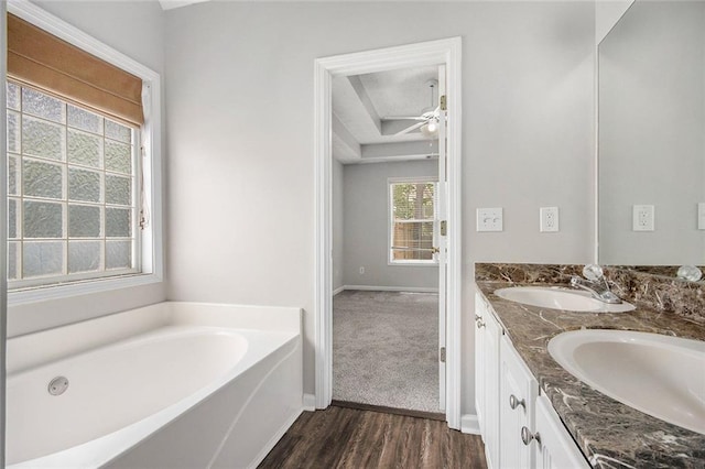 104 Terrapin Ct, Carrollton, GA 30116 - full bathroom featuring double vanity, wood finished floors, a bath, baseboards, and ceiling fan