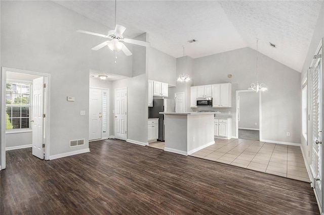 104 Terrapin Ct, Carrollton, GA 30116 - kitchen with high vaulted ceiling, freestanding refrigerator, a center island, a chandelier, and wood finished floors