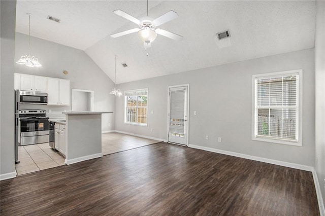 104 Terrapin Ct, Carrollton, GA 30116 - kitchen with stainless steel appliances, a chandelier, light wood-style flooring, ceiling fan, and high vaulted ceiling