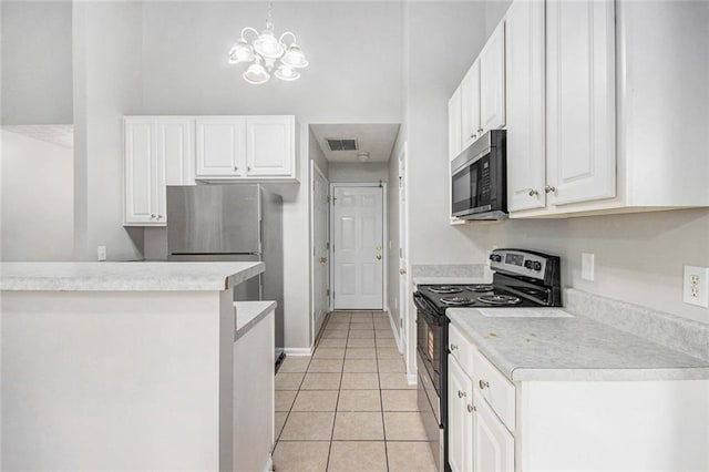 104 Terrapin Ct, Carrollton, GA 30116 - kitchen with black range with electric cooktop, light tile patterned floors, white cabinetry, and light countertops