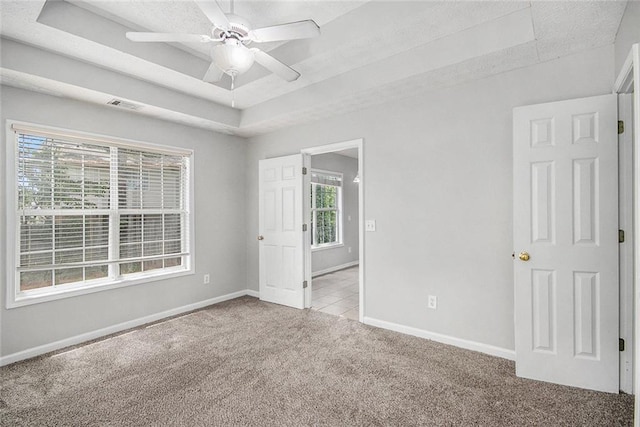104 Terrapin Ct, Carrollton, GA 30116 - unfurnished bedroom with carpet floors, a raised ceiling, baseboards, and a ceiling fan