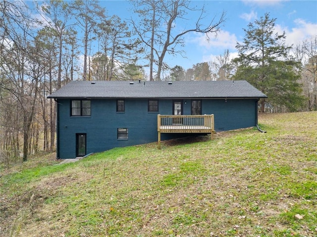 rear view of property featuring a yard and a wooden deck