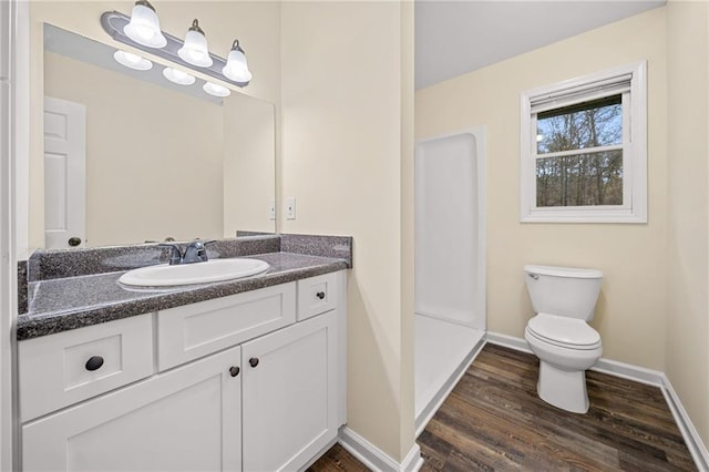 bathroom with vanity, hardwood / wood-style flooring, and toilet