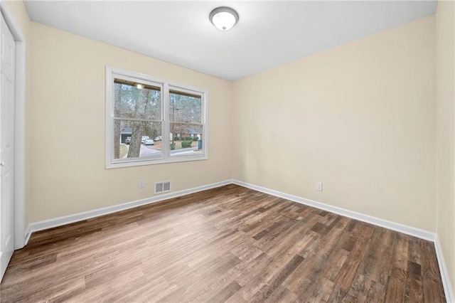 unfurnished room featuring hardwood / wood-style flooring