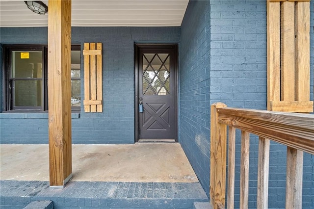 view of exterior entry with a porch