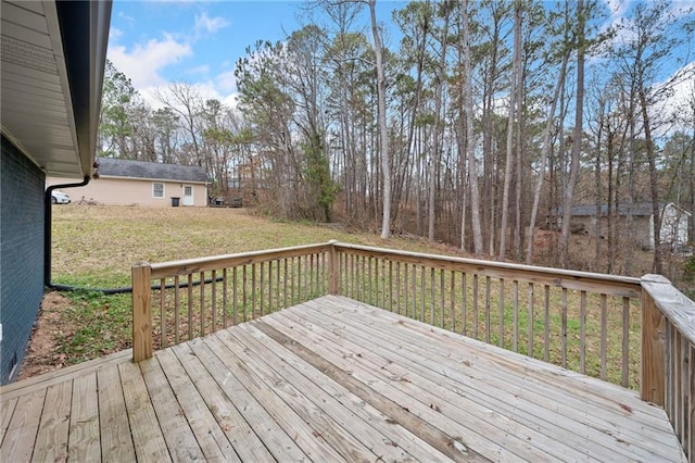 wooden terrace featuring a yard