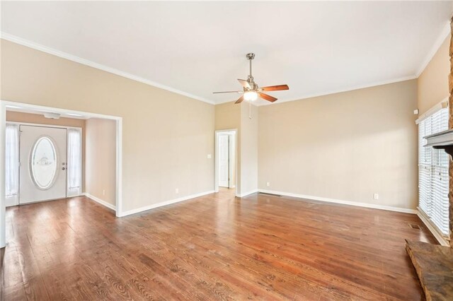 105 Spring Forest Way, Sharpsburg, GA 30277 - unfurnished living room with crown molding, a fireplace, a ceiling fan, wood finished floors, and baseboards