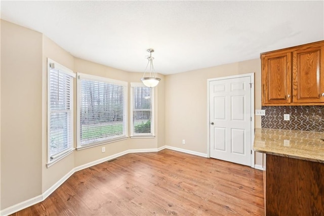 105 Spring Forest Way, Sharpsburg, GA 30277 - unfurnished dining area featuring visible vents, light wood-style flooring, and baseboards