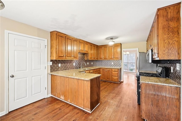 105 Spring Forest Way, Sharpsburg, GA 30277 - kitchen with a peninsula, appliances with stainless steel finishes, backsplash, and a sink