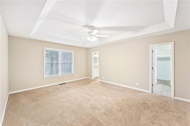 105 Spring Forest Way, Sharpsburg, GA 30277 - empty room with light carpet, visible vents, a tray ceiling, and baseboards