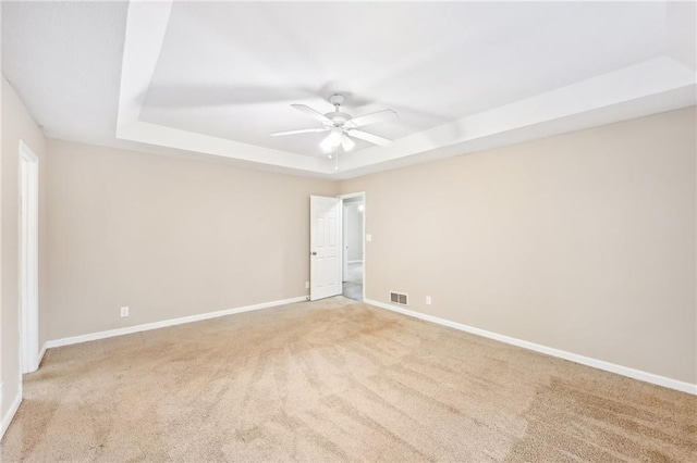 105 Spring Forest Way, Sharpsburg, GA 30277 - unfurnished room featuring a tray ceiling, light colored carpet, visible vents, ceiling fan, and baseboards