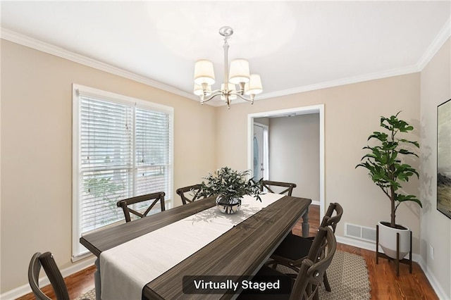 105 Spring Forest Way, Sharpsburg, GA 30277 - dining space featuring baseboards, visible vents, ornamental molding, dark wood-type flooring, and a notable chandelier