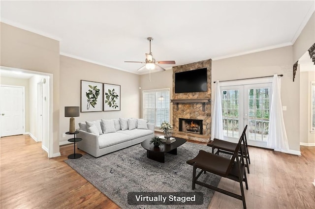 105 Spring Forest Way, Sharpsburg, GA 30277 - living area with crown molding, a stone fireplace, baseboards, and wood finished floors