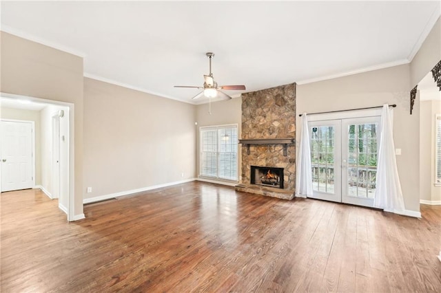 105 Spring Forest Way, Sharpsburg, GA 30277 - unfurnished living room featuring a fireplace, ornamental molding, a ceiling fan, wood finished floors, and baseboards